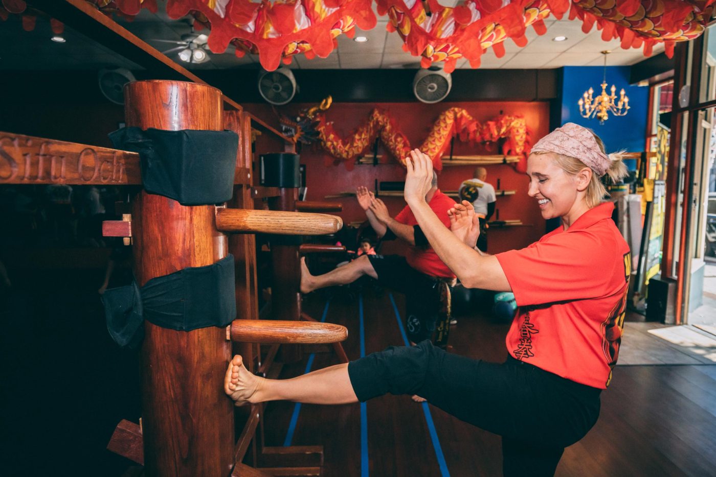 woman demonstrating an advanced wing chun classes wooden dummy training technique